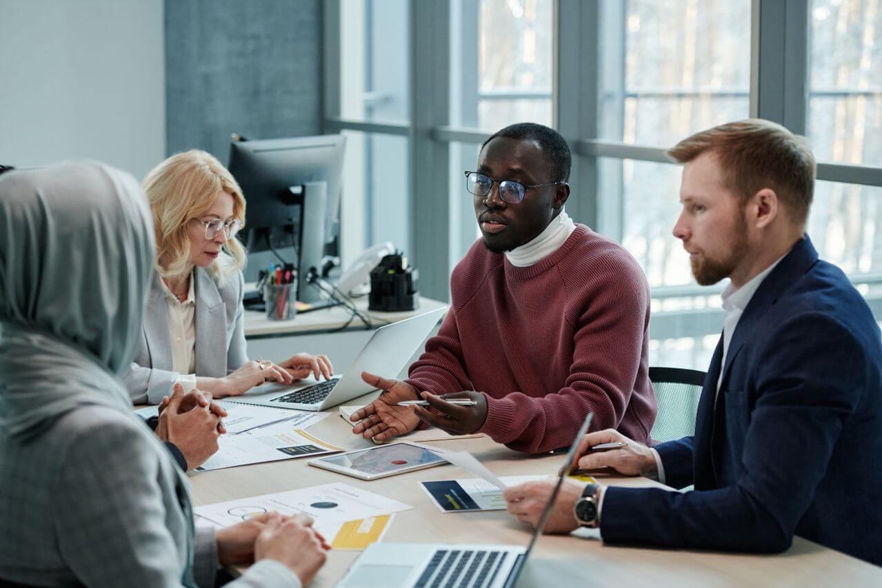 A lawyer explaining options to clients around a meeting table