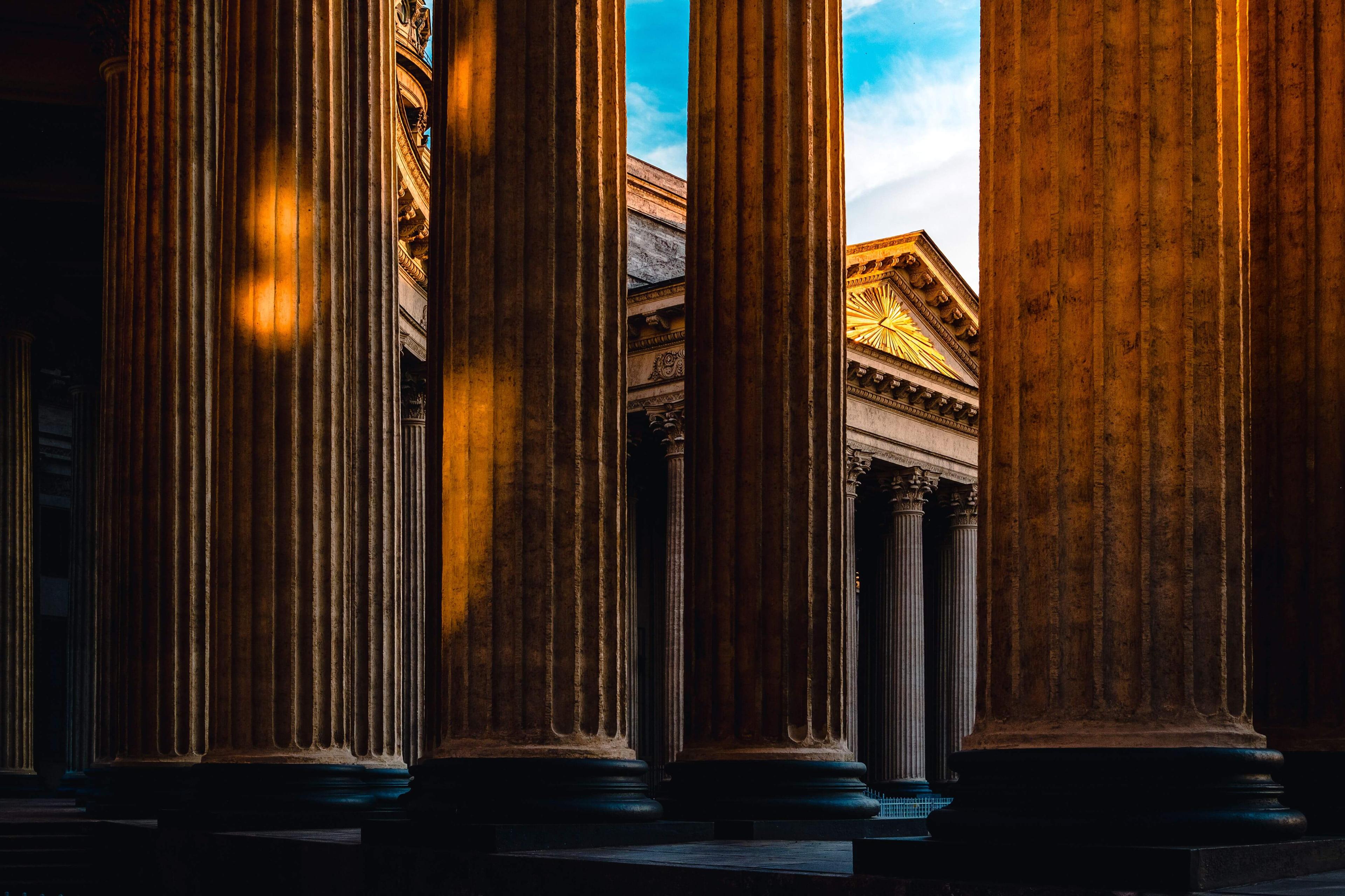 Stone columns of a courthouse portico at golden hour